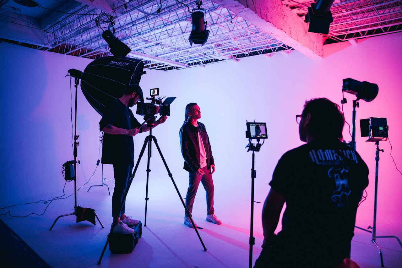 Cinematic setup in a studio with colorful stage lighting showcasing video production.